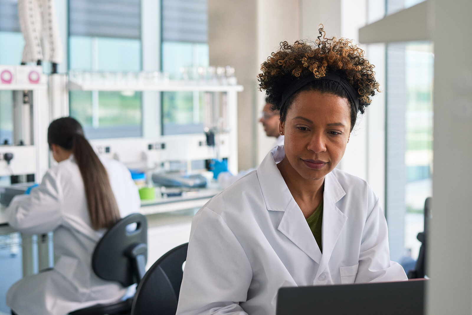 A researcher working at a laptop in an Oxford North lab