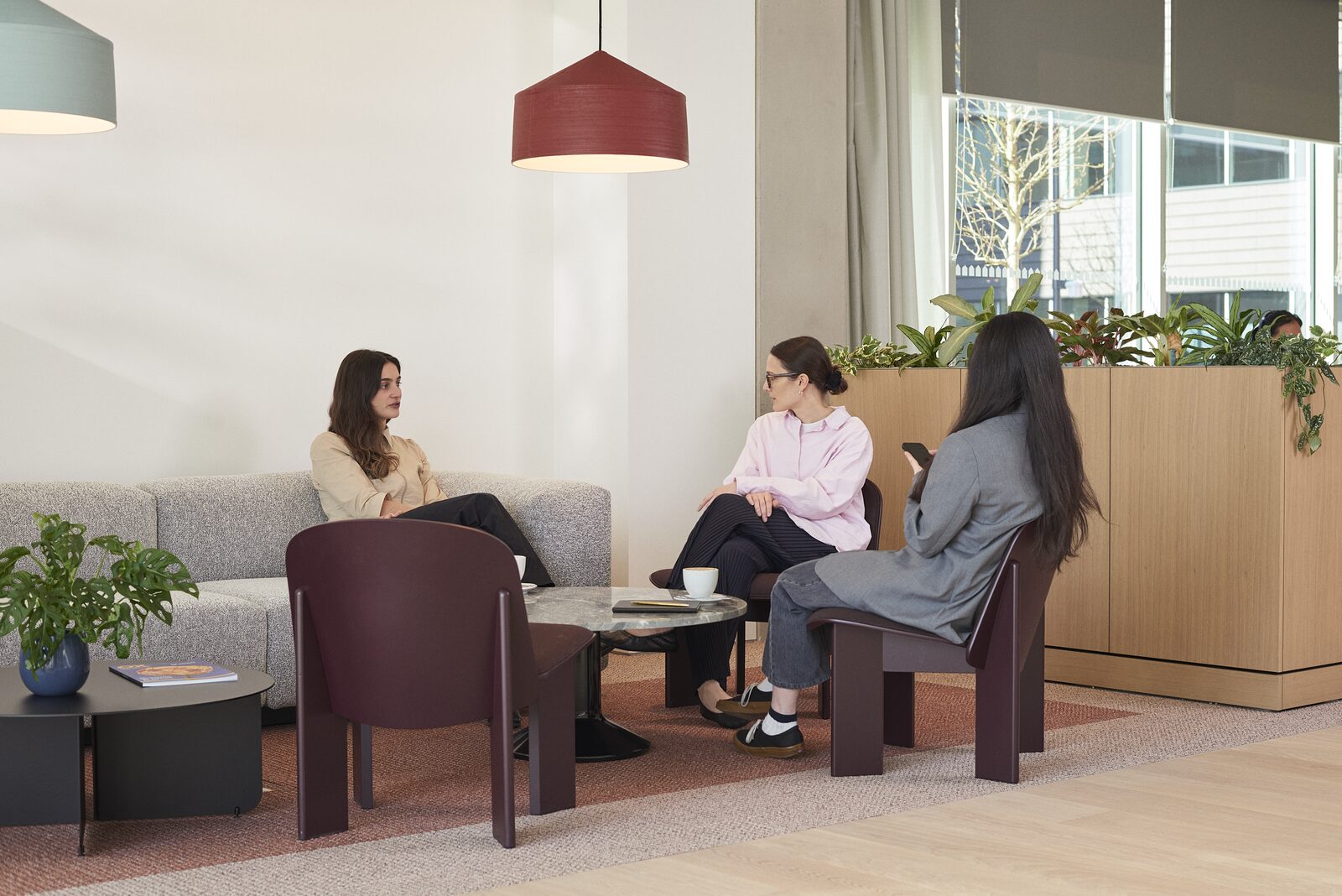 Colleagues talking in an Oxford North breakout space